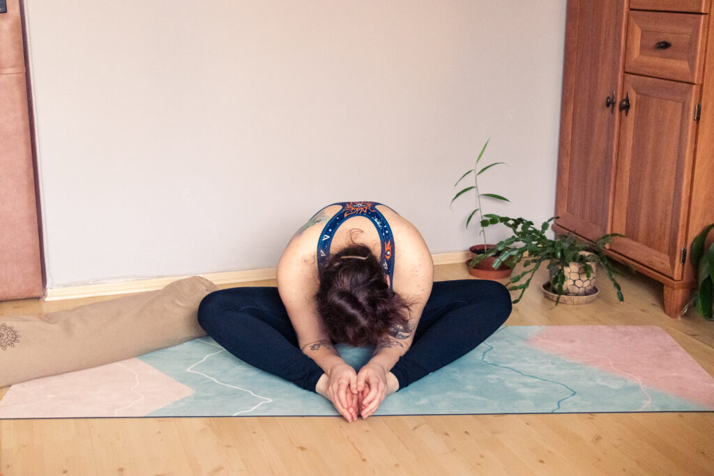 a yogini doing the bound angle pose, butterfly pose