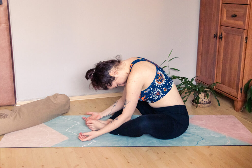 young yogini performing yin yoga butterfly pose with incorrect head and neck alignment