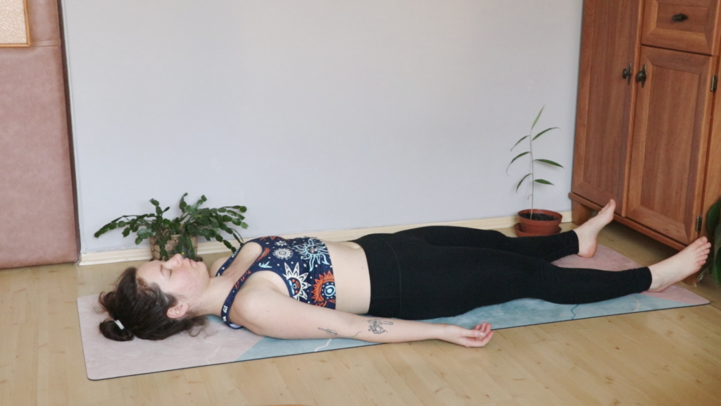 young yogini in savasana, corpse pose