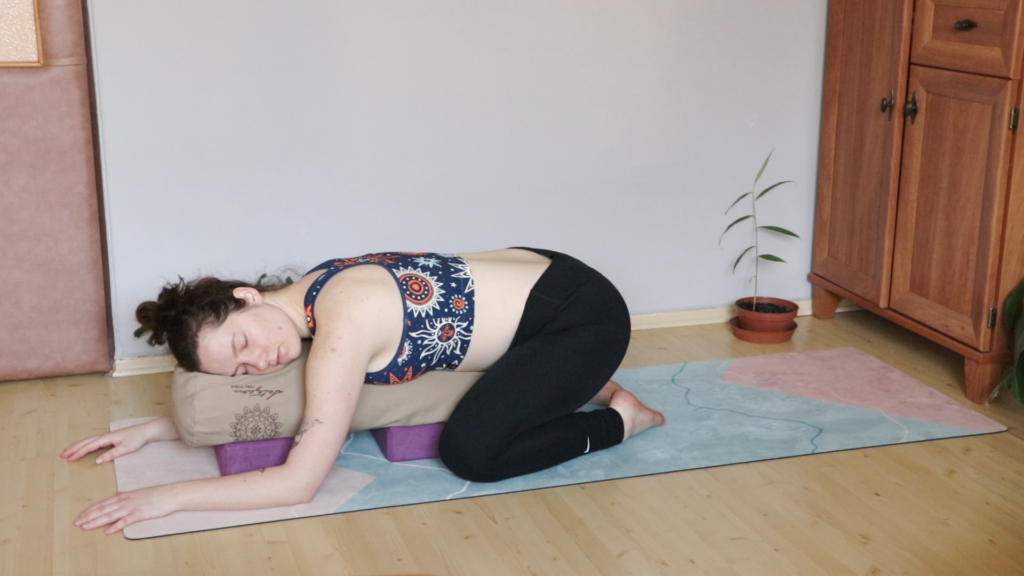 yogini during restorative yoga class in the supported child's pose